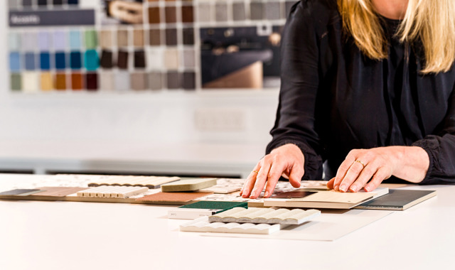 Close up of an interior designer assembling finishes for a workplace project